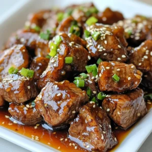 - 1 lb sirloin steak, cut into bite-sized cubes - 1/4 cup honey - 1/4 cup soy sauce - 2 tablespoons sesame oil - 3 cloves garlic, minced - 1 teaspoon freshly grated ginger - 1 tablespoon cornstarch - 2 tablespoons water - 1/4 teaspoon freshly ground black pepper These ingredients come together to create a sweet and sticky sauce that coats each steak bite. The sirloin steak provides a tender base, while honey adds sweetness. Soy sauce brings umami, and sesame oil gives a rich flavor. Garlic and ginger offer a nice zing. Finally, cornstarch thickens the sauce into a glossy coating. - 1 green onion, finely sliced - A sprinkle of sesame seeds Using green onions adds a fresh crunch. Sesame seeds give a nutty finish and a delightful visual touch. These garnishes enhance the dish, making it appealing and flavorful. - For a gluten-free option, use tamari instead of soy sauce. - You can replace honey with maple syrup or agave for a different sweetness. If you're looking for a lower-sugar option, these substitutes work well. Each choice can change the flavor slightly but still keep the dish tasty. Experiment and find what you love best! {{ingredient_image_2}} Preparing the marinade To start, take a medium bowl. Combine 1/4 cup honey, 1/4 cup soy sauce, and 2 tablespoons sesame oil. Add 3 cloves of minced garlic, 1 teaspoon of grated ginger, and 1/4 teaspoon of black pepper. Whisk it well until everything mixes smoothly. Tossing steak in marinade Next, add 1 pound of sirloin steak cubes to the bowl. Gently toss the steak in the marinade until every piece gets a nice coat. Cover the bowl with plastic wrap. Duration and tips for marinating Let it sit in the fridge for at least 30 minutes. You can marinate it for up to 2 hours to deepen the flavor. This soak is key for making your steak bites tender and tasty. Heating the skillet Heat a large skillet or wok over medium-high heat. Make sure it's hot before adding the steak. This step helps to sear the meat nicely. Cooking time and techniques After marinating, take the steak from the marinade but keep the marinade for later. Place the steak in the hot skillet. Cook them for 3-4 minutes. Stir frequently to ensure they brown evenly and reach your preferred doneness. Use of marinade Once the steak is cooked, pour the reserved marinade over the bites. Let it come to a gentle simmer to enhance the flavors. Preparing the cornstarch slurry In a small bowl, mix 1 tablespoon of cornstarch with 2 tablespoons of water. Stir until it is smooth. This mixture will help thicken your sauce. Combining sauce and steak bites Gradually add the cornstarch slurry to the skillet. Stir it in while cooking for 1-2 minutes. This process will thicken the sauce and give it a glossy, sticky texture. Watching for desired texture Keep an eye on the sauce as it thickens. You want it to cling to the steak bites well. When it reaches the right consistency, remove the skillet from heat. Enjoy your sweet and sticky steak bites! - Achieving the right doneness: I like my steak medium-rare, which means an internal temp of 130°F. Use a meat thermometer for best results. Cook longer for medium or well-done steak. - Tips for even cooking: Cut your steak into uniform cubes to ensure even cooking. This will help all pieces cook at the same rate. - Adding spice with chili flakes: If you like heat, add chili flakes to the marinade. This gives your steak a nice kick. Start with a small amount and adjust to taste. - Alternative marinades: Try using teriyaki sauce or a mix of balsamic vinegar and honey for a different flavor. Each option gives a unique twist to the steak bites. - Plating ideas: Serve the steak bites on a stylish platter. Use toothpicks for easy eating. This makes it fun for guests. - Suggested accompaniments: Pair with a fresh salad or steamed veggies. They balance the sweet flavors of the steak bites and add color to your plate. Pro Tips Marination Time: Allow the steak to marinate for at least 2 hours if possible; this enhances the flavor and tenderness of the meat. High Heat for Searing: Make sure your skillet or wok is properly preheated to achieve a nice sear on the steak bites, locking in the juices. Thickening the Sauce: Stir the cornstarch slurry continuously as you add it to the marinade to prevent lumps and ensure a smooth, glossy sauce. Serving Suggestion: For an impressive presentation, serve the steak bites on a platter with toothpicks and a side of the reserved dipping sauce. {{image_4}} If you want to switch things up, try different meats. You can use flank steak or ribeye for a more tender bite. If you're looking for a lighter option, chicken works great. Cut the chicken into pieces like the steak. Tofu is also a fantastic choice for a vegetarian version. Just press the tofu to remove water and cut it into cubes. Marinade the tofu just like the steak for the best flavor. You can easily change the flavor of your steak bites. For a sweet and spicy kick, add some chili flakes or hot sauce to the marinade. This will bring heat and depth. If you prefer herbs, try adding fresh rosemary or thyme. These herbs will add a savory touch. You could even mix in citrus juice for a bright flavor. Sweet and sticky steak bites make great appetizers. Serve them on a platter with toothpicks for easy eating. You can also serve them as a main dish. Just add rice or a fresh salad on the side. This will balance the rich flavors. You can drizzle extra sauce over the top for a nice touch. To keep your sweet and sticky steak bites fresh, store them in the fridge. Place them in an airtight container. They will stay good for up to three days. If you want to keep them longer, consider freezing. Use a freezer-safe bag or container. They can last for up to three months in the freezer. When reheating, aim to maintain the sticky texture. The best method is to use the stove. Heat a skillet on low heat. Add a bit of oil to prevent sticking. Place the steak bites in the pan. Stir gently until warmed through. Avoid using high heat; this can dry them out. For microwave reheating, use a covered dish. Heat in short bursts and check often. Stored leftovers last about three days in the fridge. After this period, the risk of spoilage increases. Signs of spoilage include an off smell and discoloration. If the steak looks slimy or has changed color, it’s best to throw it away. Always trust your senses; if it seems off, do not eat it. For sweet and sticky steak bites, I recommend using sirloin steak. Sirloin is tender and flavorful. You can also try flank or tenderloin for a different taste. Both cuts provide a nice texture. They work well with the sweet marinade. Yes, you can make this recipe gluten-free. Simply substitute soy sauce with tamari. Tamari is made without wheat. It gives a similar taste. You can also use coconut aminos as another option. Both will keep your dish tasty and gluten-free. To reduce sweetness, cut back on honey. You can use half the amount. Another option is to add more soy sauce. This will balance the flavors. You can also use a sugar substitute like stevia or monk fruit. These replacements can help maintain sweetness without the sugar. Sweet and sticky steak bites go well with many sides. Here are some ideas: - Steamed rice or jasmine rice - Roasted vegetables like broccoli or carrots - A fresh salad with a light dressing - Garlic bread for a tasty contrast - Noodles tossed in sesame oil and veggies These sides will enhance your meal and complement the steak bites perfectly. In this blog post, I shared how to create delicious sweet and sticky steak bites. You learned about key ingredients like sirloin steak, honey, and soy sauce. I also provided tips for marinating, cooking, and thickening your sauce for the best texture. Don't forget to explore ingredient substitutes and variations, plus how to store and reheat leftovers. With these easy steps, you can impress your guests or enjoy a tasty meal at home. Now, it's your turn to try this recipe and make it your own!